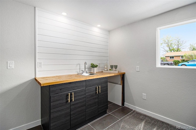 6775 Newland St, Arvada, CO 80003 - indoor wet bar featuring baseboards, dark tile patterned floors, and recessed lighting