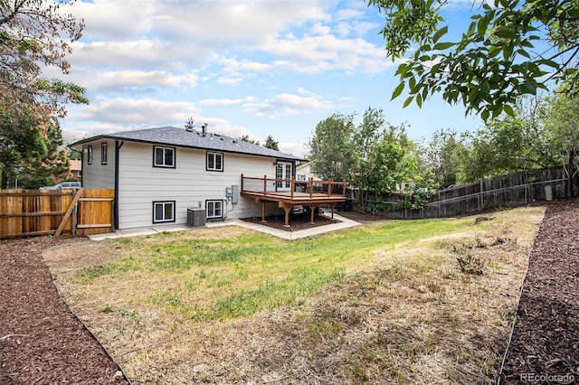 6775 Newland St, Arvada, CO 80003 - rear view of property featuring a wooden deck and central AC