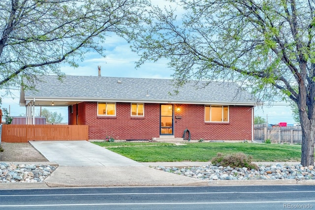 9100 Yucca Way, Thornton, CO 80229 - ranch-style house with brick siding, roof with shingles, fence, and a front yard