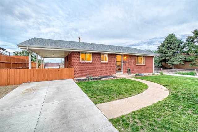 9100 Yucca Way, Thornton, CO 80229 - view of front of house featuring a front lawn, brick siding, a gate, and fence