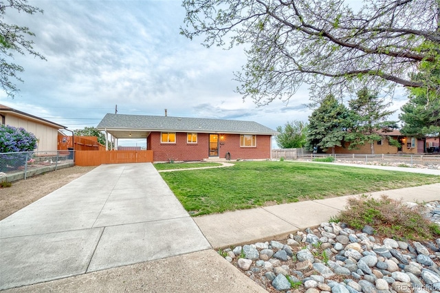 9100 Yucca Way, Thornton, CO 80229 - ranch-style house with concrete driveway, a front yard, brick siding, and fence private yard