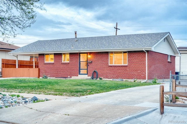 9100 Yucca Way, Thornton, CO 80229 - single story home with brick siding, roof with shingles, a front lawn, and fence