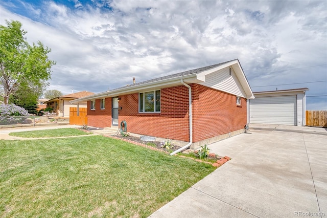 9100 Yucca Way, Thornton, CO 80229 - view of front facade with an outbuilding, fence, a front yard, brick siding, and a detached garage