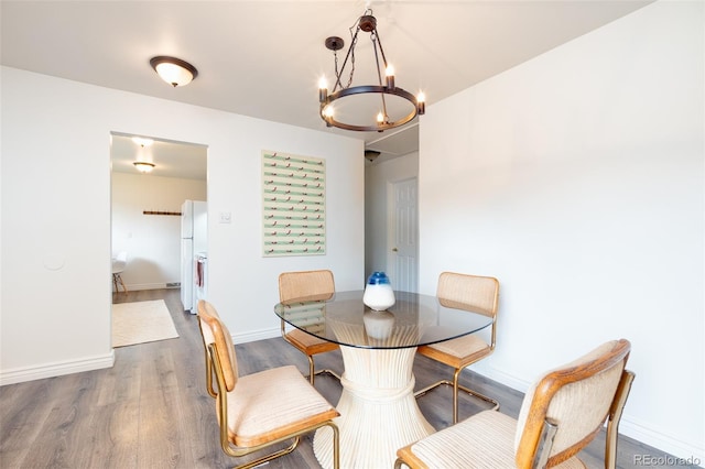 9100 Yucca Way, Thornton, CO 80229 - dining area featuring baseboards, an inviting chandelier, and wood finished floors