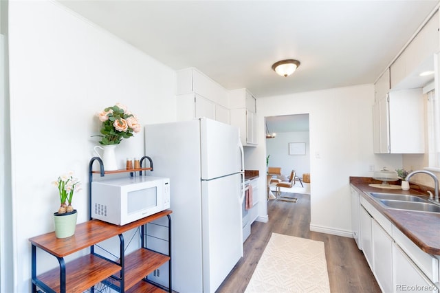 9100 Yucca Way, Thornton, CO 80229 - kitchen featuring white cabinets, wood finished floors, white appliances, and a sink