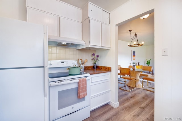 9100 Yucca Way, Thornton, CO 80229 - kitchen with under cabinet range hood, white appliances, white cabinets, light wood-style floors, and tasteful backsplash