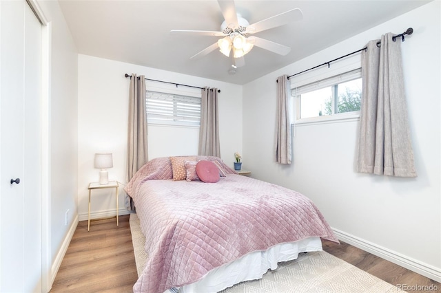 9100 Yucca Way, Thornton, CO 80229 - bedroom featuring baseboards, a closet, light wood-style flooring, and a ceiling fan