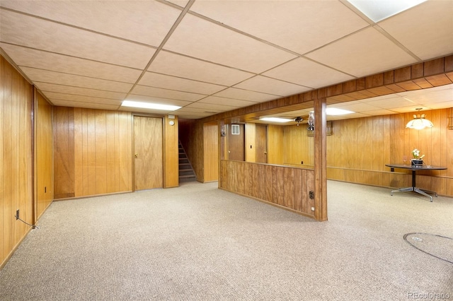 9100 Yucca Way, Thornton, CO 80229 - finished below grade area with carpet flooring, a drop ceiling, stairway, and wooden walls