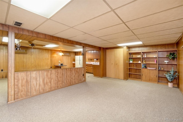 9100 Yucca Way, Thornton, CO 80229 - finished basement featuring freestanding refrigerator, wooden walls, carpet flooring, and visible vents