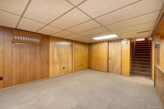 9100 Yucca Way, Thornton, CO 80229 - finished below grade area with a paneled ceiling, stairs, carpet flooring, and wooden walls