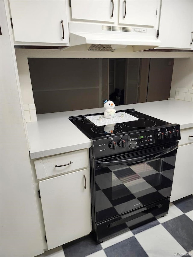 kitchen with white cabinets and black range