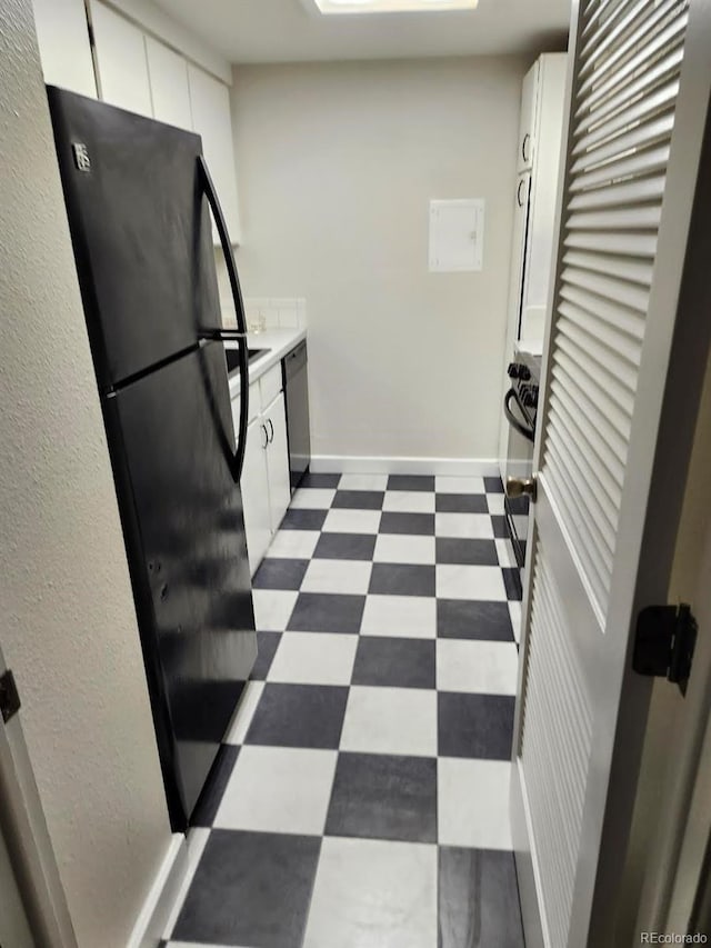 kitchen with white cabinets, black refrigerator, and stainless steel dishwasher