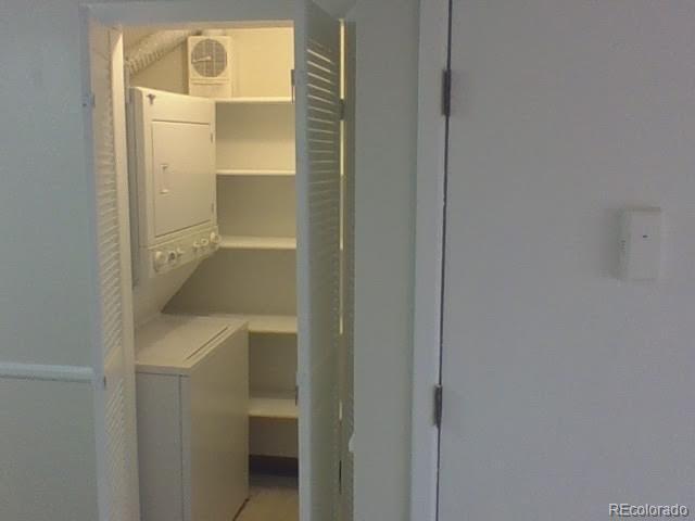 laundry room featuring stacked washer and clothes dryer