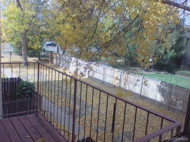12172 Huron St Unit 207, Denver, CO 80234 - wooden terrace featuring a fenced backyard