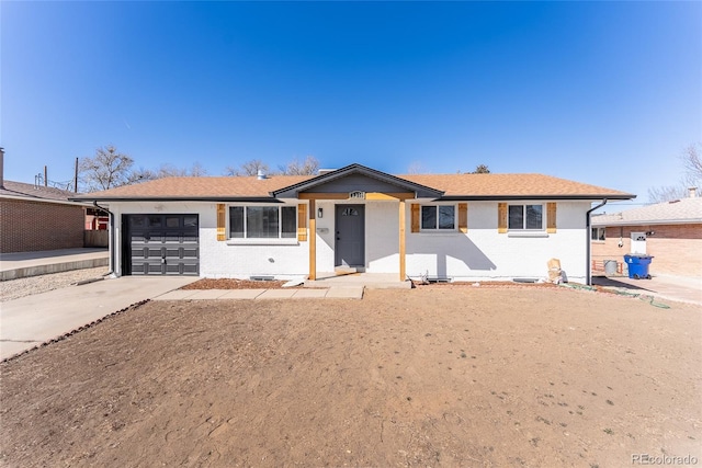 ranch-style house with driveway, an attached garage, and brick siding