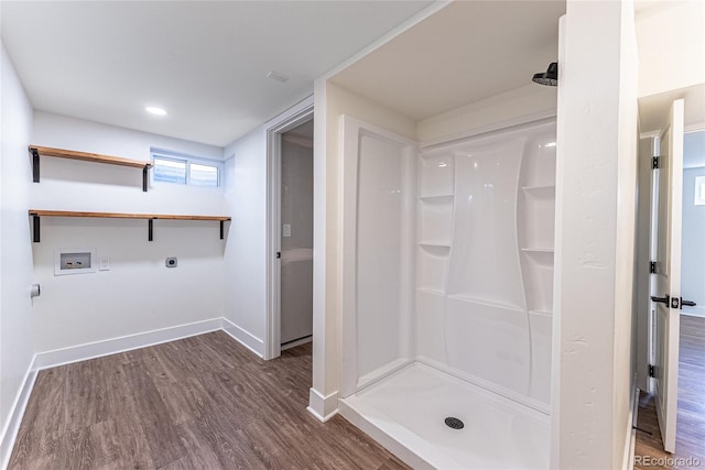 bathroom featuring a stall shower, baseboards, wood finished floors, and recessed lighting