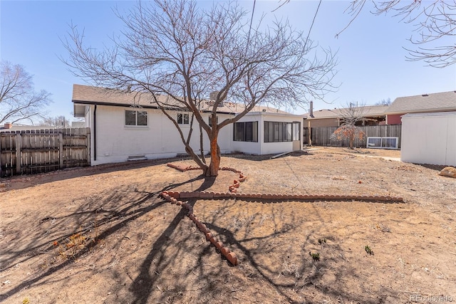 rear view of property featuring crawl space, a fenced backyard, and brick siding