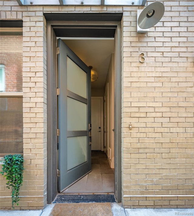 1323 Elati St Unit 3, Denver, CO 80204 - view of exterior entry with brick siding and a security system