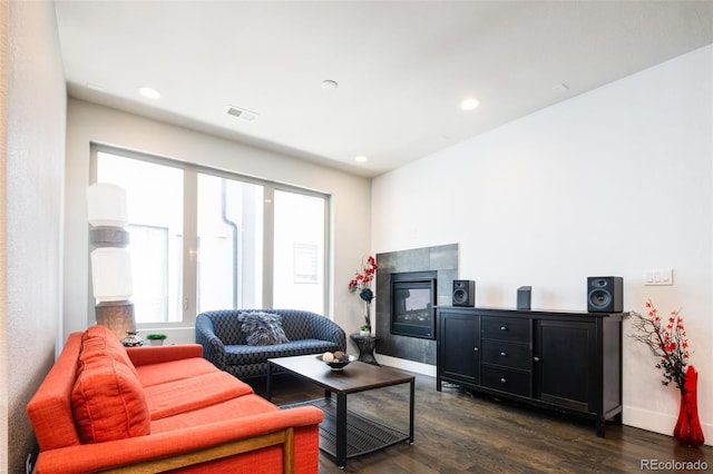 1323 Elati St Unit 3, Denver, CO 80204 - living area with dark wood-style floors, a tiled fireplace, baseboards, and recessed lighting