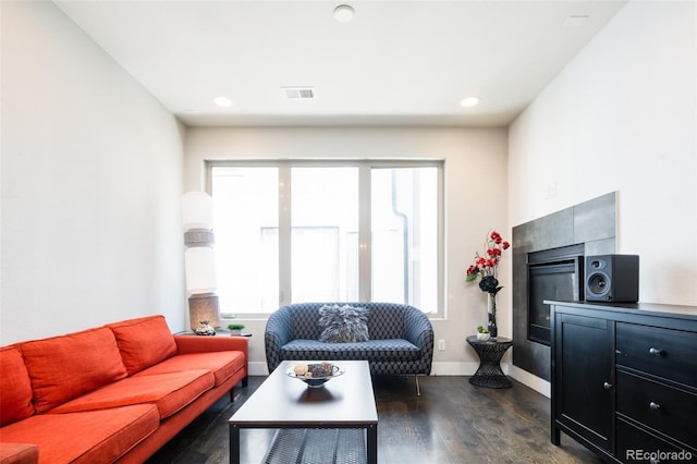 1323 Elati St Unit 3, Denver, CO 80204 - living room featuring dark wood-style flooring, a tile fireplace, plenty of natural light, baseboards, and recessed lighting