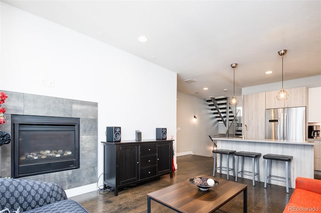 1323 Elati St Unit 3, Denver, CO 80204 - living area featuring stairway, dark wood-type flooring, recessed lighting, baseboards, and a tile fireplace