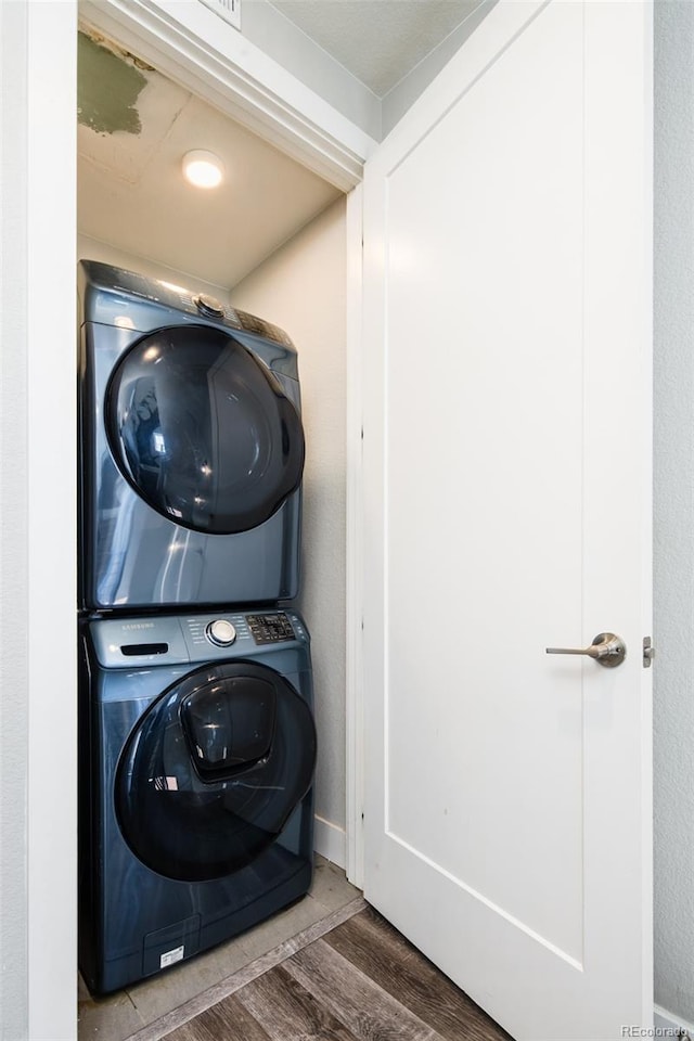 1323 Elati St Unit 3, Denver, CO 80204 - washroom featuring stacked washer / dryer and wood finished floors