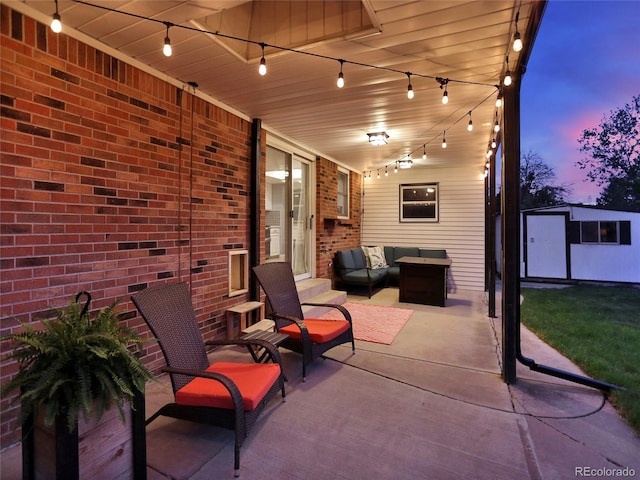 13935 E Idaho Pl, Aurora, CO 80012 - patio terrace at dusk featuring outdoor lounge area, an outbuilding, and a storage shed