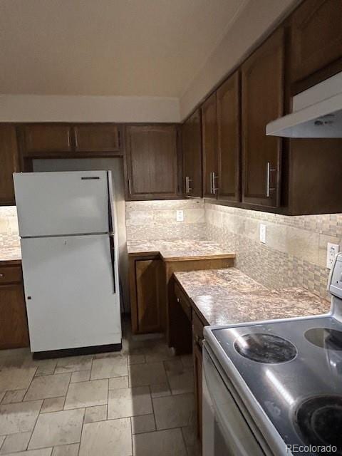 kitchen featuring light countertops, white appliances, under cabinet range hood, and tasteful backsplash