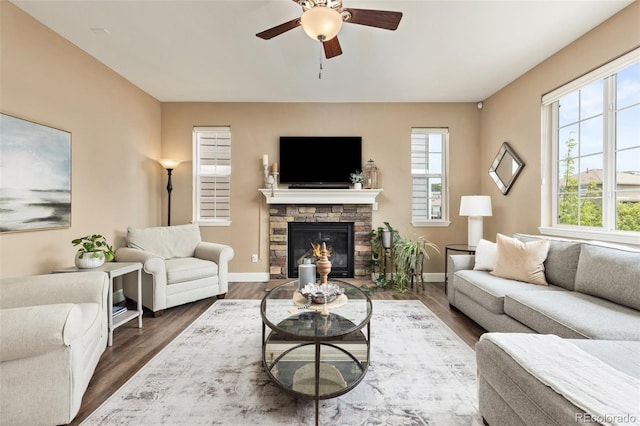 3319 Starry Night Loop, Castle Rock, CO 80109 - living area with a ceiling fan, a fireplace, wood finished floors, and baseboards