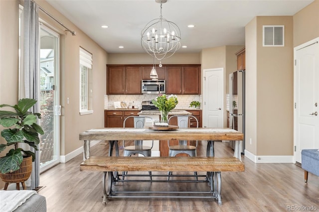 3319 Starry Night Loop, Castle Rock, CO 80109 - dining area featuring baseboards, light wood-style flooring, a chandelier, and recessed lighting