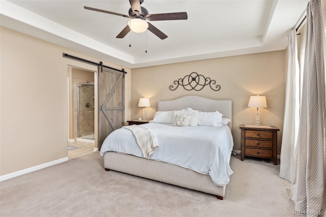 3319 Starry Night Loop, Castle Rock, CO 80109 - carpeted bedroom featuring a barn door, a tray ceiling, baseboards, and connected bathroom
