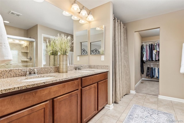 3319 Starry Night Loop, Castle Rock, CO 80109 - full bath with a shower stall, double vanity, baseboards, and tile patterned floors