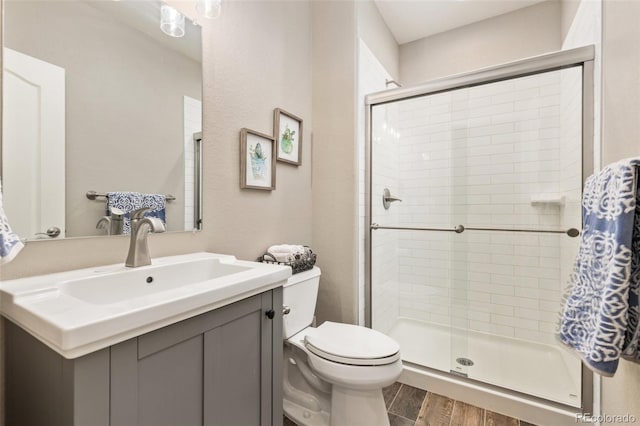 3319 Starry Night Loop, Castle Rock, CO 80109 - bathroom with toilet, a shower stall, wood finished floors, and vanity