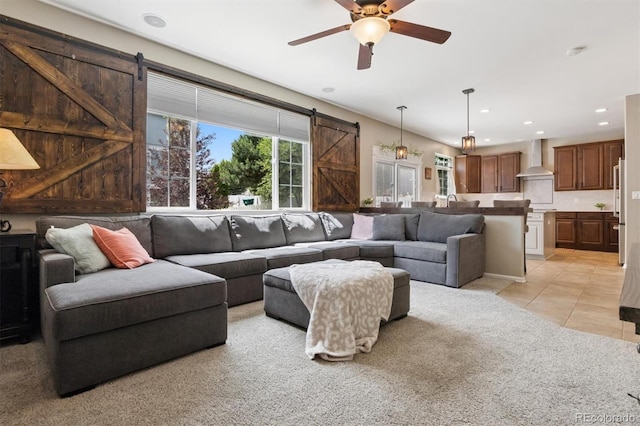 3540 Brushwood Dr, Castle Rock, CO 80109 - living area with a barn door, recessed lighting, light tile patterned floors, a ceiling fan, and light carpet