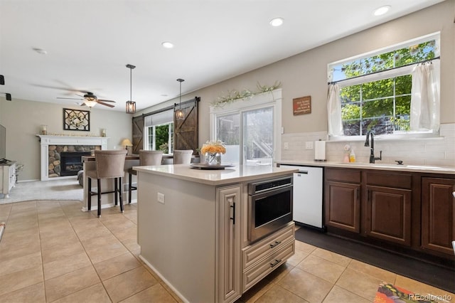 3540 Brushwood Dr, Castle Rock, CO 80109 - kitchen with white dishwasher, light countertops, light tile patterned flooring, a ceiling fan, and recessed lighting