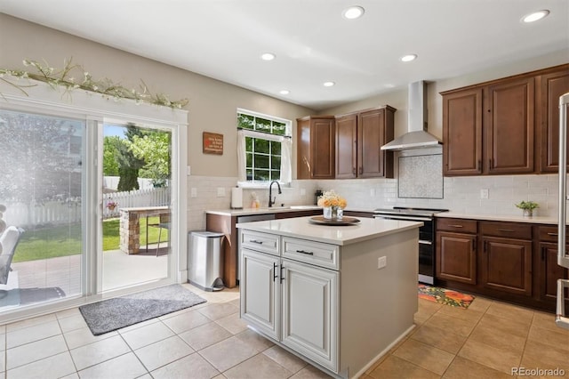 3540 Brushwood Dr, Castle Rock, CO 80109 - kitchen featuring wall chimney exhaust hood, stainless steel range with electric cooktop, light countertops, backsplash, and a kitchen island