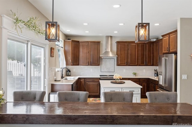 3540 Brushwood Dr, Castle Rock, CO 80109 - kitchen featuring wall chimney range hood, high end fridge, decorative backsplash, a center island, and recessed lighting