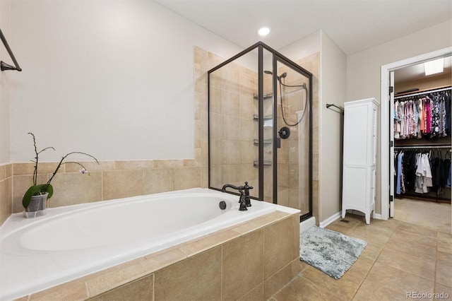3540 Brushwood Dr, Castle Rock, CO 80109 - full bathroom featuring a garden tub, a shower stall, a spacious closet, and tile patterned flooring