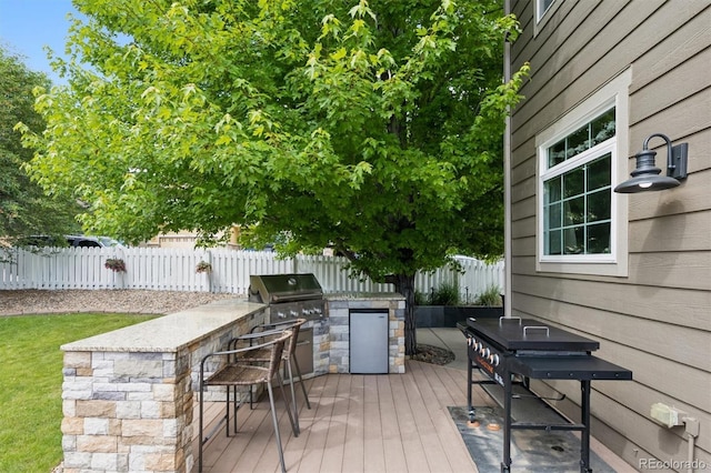 3540 Brushwood Dr, Castle Rock, CO 80109 - wooden deck with an outdoor kitchen and a fenced backyard