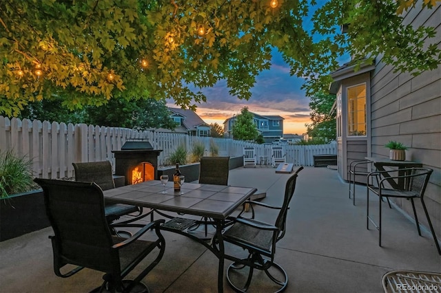 3540 Brushwood Dr, Castle Rock, CO 80109 - patio terrace at dusk with outdoor dining space, a patio, and a fenced backyard