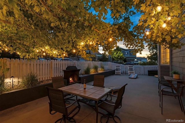 3540 Brushwood Dr, Castle Rock, CO 80109 - patio terrace at dusk featuring outdoor dining space, a patio, and a fenced backyard