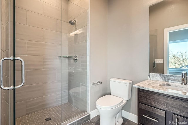 bathroom featuring vanity, toilet, and walk in shower