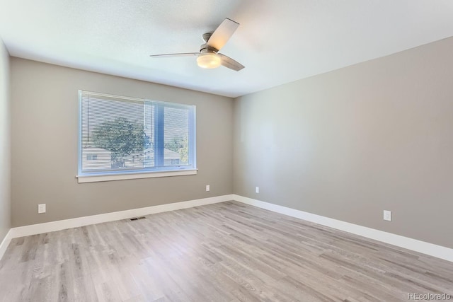 spare room with light hardwood / wood-style flooring and ceiling fan