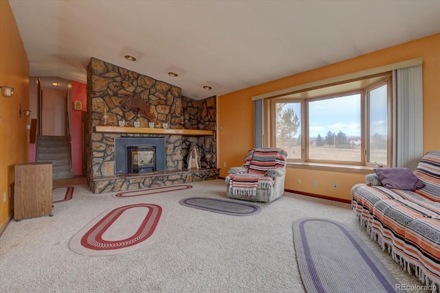 carpeted living room featuring vaulted ceiling and a fireplace