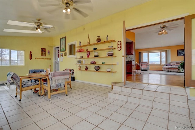 tiled dining area featuring ceiling fan