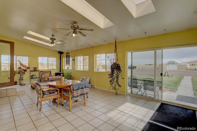 dining area with ceiling fan, vaulted ceiling, and light tile patterned floors