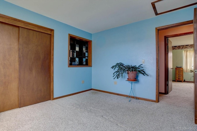 unfurnished bedroom featuring light colored carpet