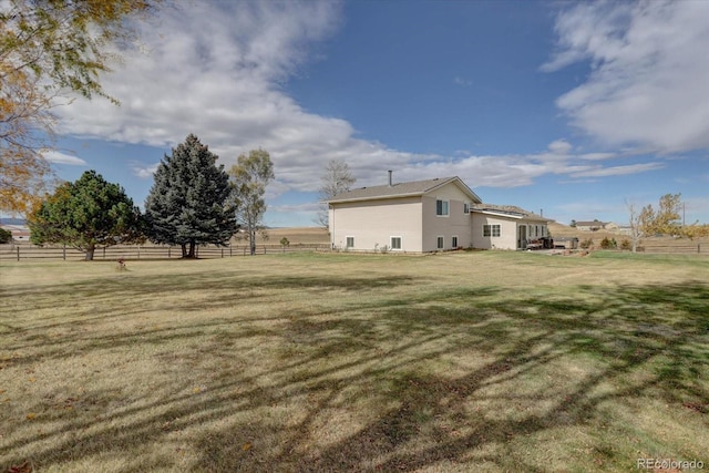 view of yard with a rural view