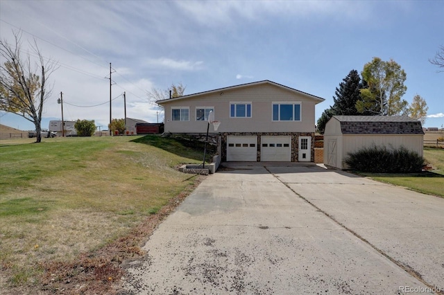 view of front of home with a storage unit, a front yard, and a garage