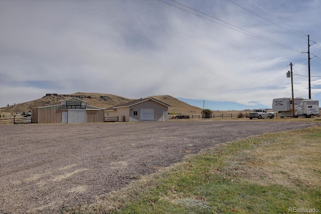 view of front of house with a mountain view and an outdoor structure